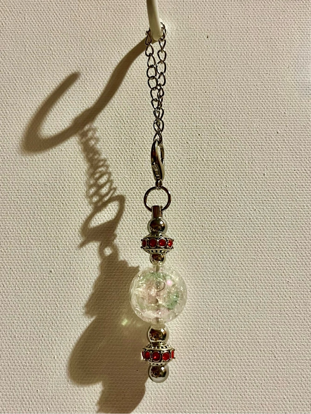Cracked Iridescent Crystal Globe Keychain with Red Rhinestone Accent Detailing